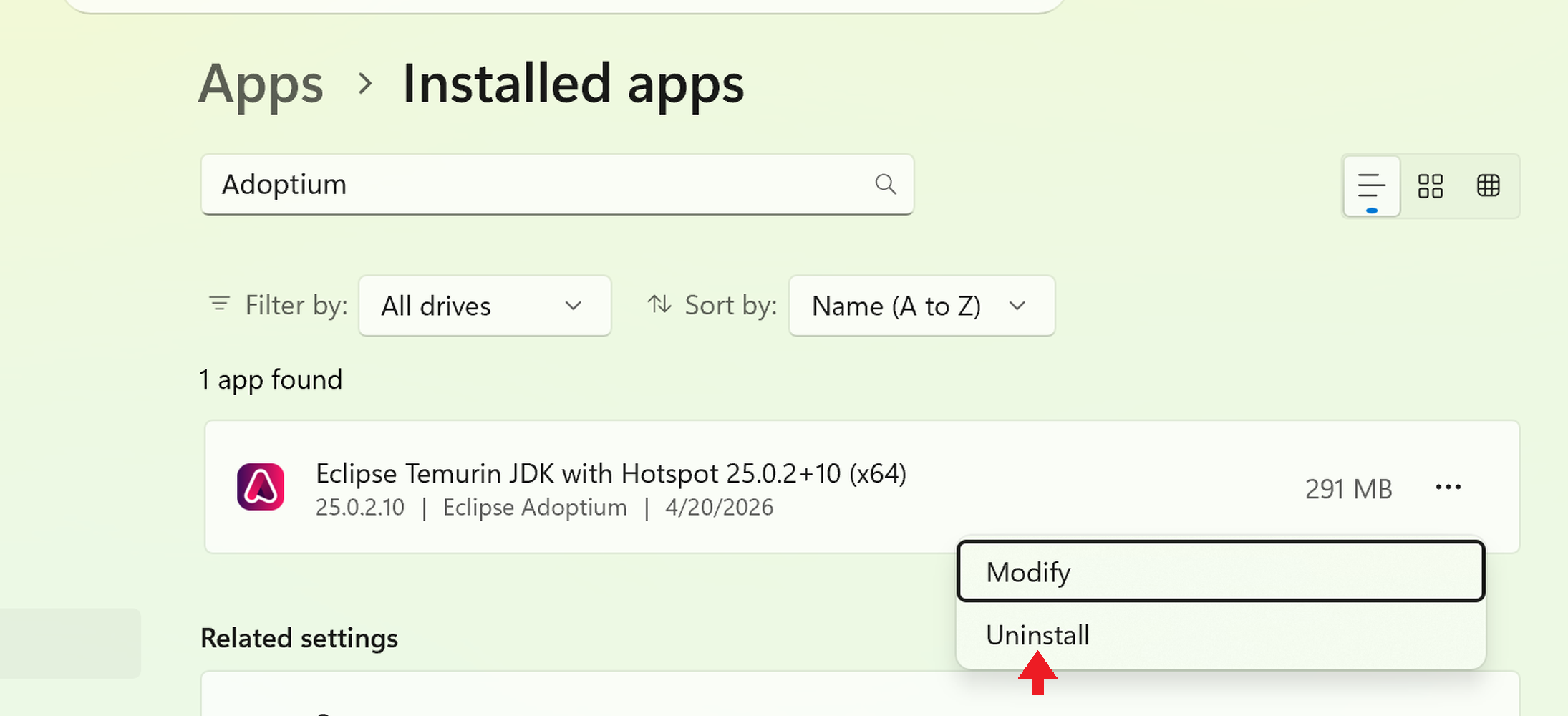 The '⋯' menu is expanded showing 'Modify' and 'Uninstall' entries. A red arrow points to 'Uninstall'